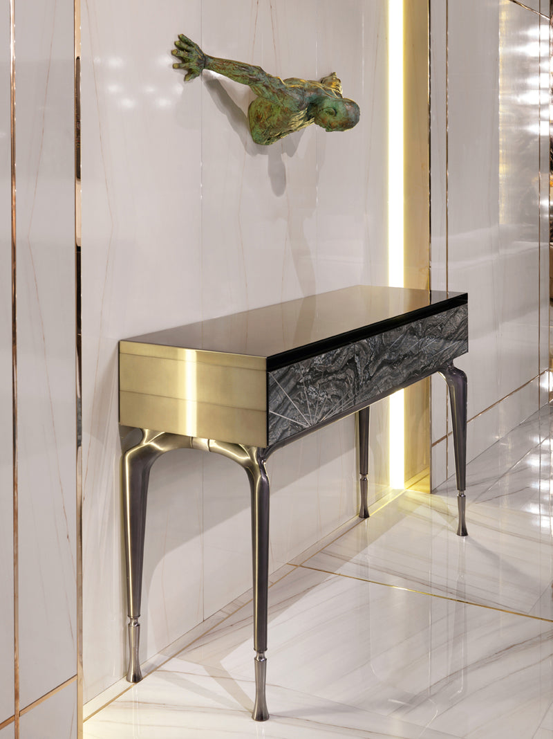 A Symphony of Light and Design: The Aurora Console. Visionnaire's masterpiece features a captivating interplay of materials, including brushed stainless steel, marble inlay, and sleek aluminum legs. This sculptural piece elevates any space with its artistic flair and modern functionality.