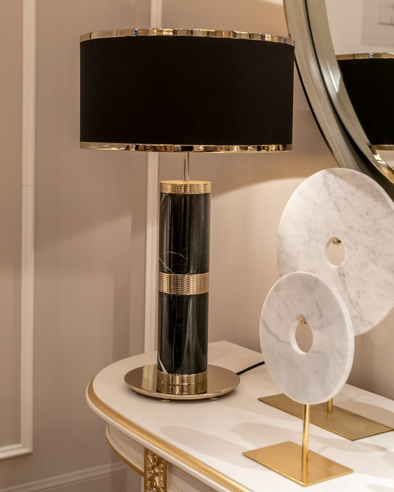 Heirloom-quality table lamp featuring a marble base and gleaming gold accents. Perfect for luxury living rooms and entryways.