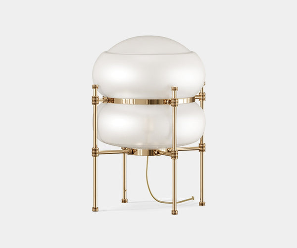 Chevalier: Sculptural Table Lamp in Gold-Plated Brass & Glass.  The Chevalier table lamp by Mezzo Collection stuns with its sculptural brass frame and elegant glass shade, casting a captivating glow in any modern living space.