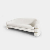 Elegant cream velvet Hutton Sofa with a curvaceous silhouette and brass detailing, ideal for luxury living spaces.