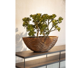 Modern bronze planter with wave-like design perfect for luxury real estate and upscale interiors.