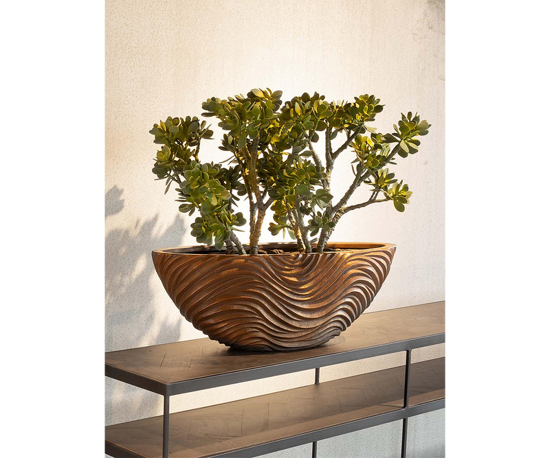 Modern bronze planter with wave-like design perfect for luxury real estate and upscale interiors.