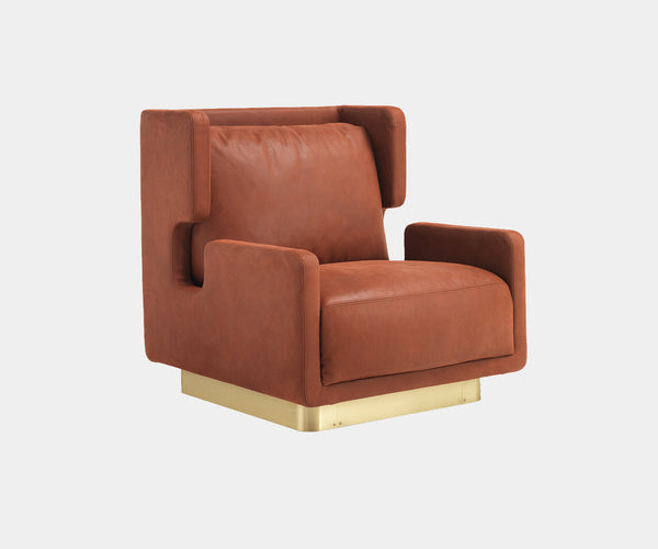 Daytona Haring Armchair: Modern luxury meets statement design in the Haring armchair, featuring plush red leather and a striking satin brass base.