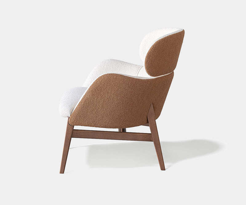 High-quality luxury armchair with unique two-shell design for sophisticated living spaces.