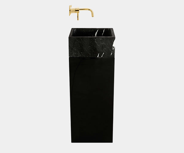 High-end bathroom vanity featuring a Colosseum pedestal sink with exquisite black marble and glossy lacquered base.