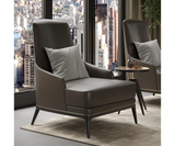 Comfortable Redd armchair with curvy silhouette, black oak wood frame, and brushed brass accents for high-end design.