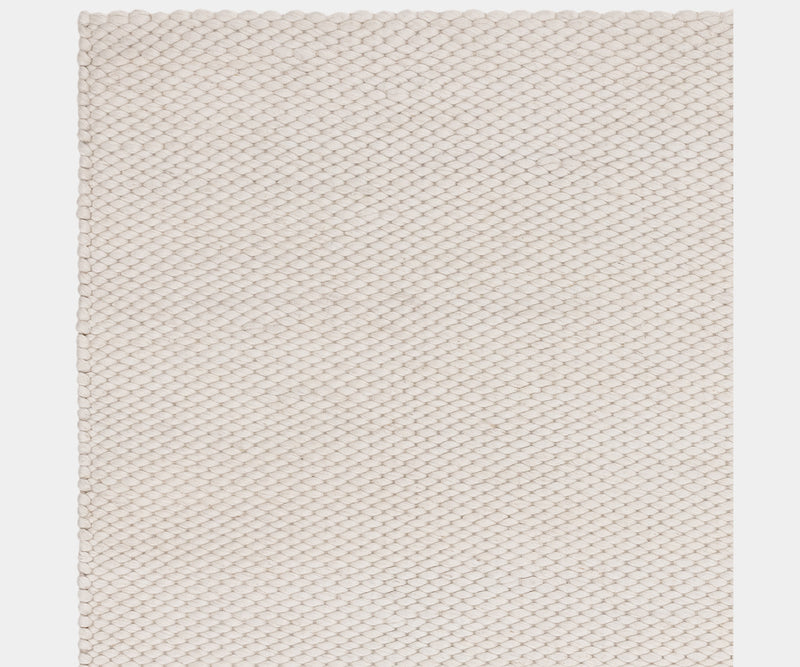 Handcrafted Zander Ivory rug in a wool blend, perfect for luxury interiors.