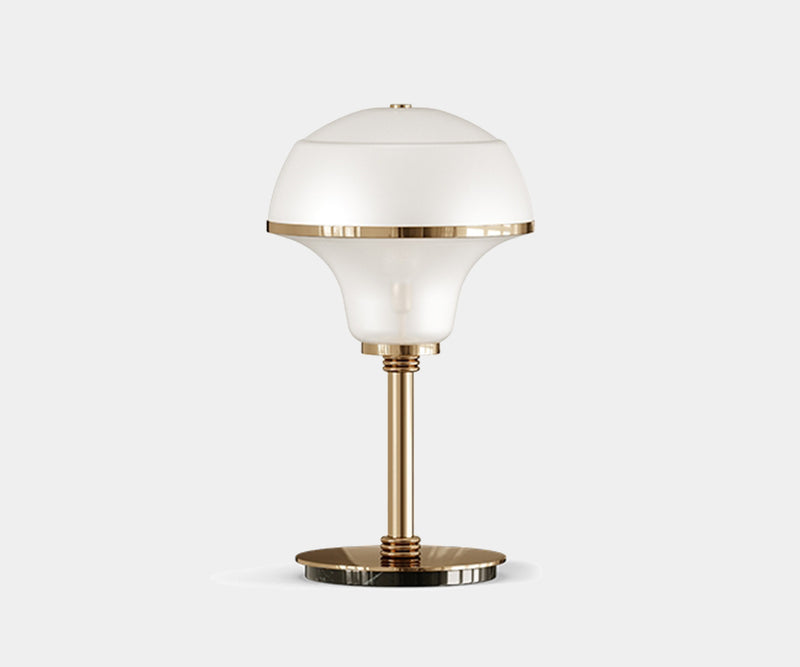 Illuminate Your Entryway with the Harlow Table Lamp.  Add a touch of mid-century modern elegance to your entryway with the Harlow table lamp. This luxurious lamp by Mezzo Collection features a captivating design in glass, marble, and gold, casting a warm and inviting glow.