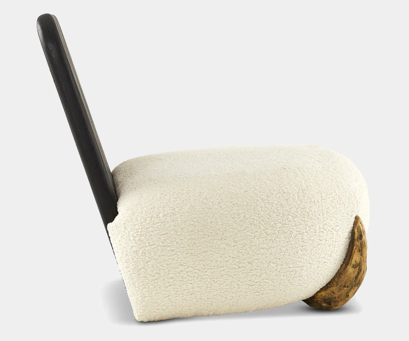 Modern cream bouclé lounge chair with unique Shou Sugi Ban backrest, solid brass buttons, and bronze cast resin feet.