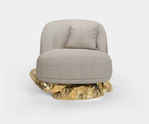 Modern Armchair with Sculptural Design: The Angra Armchair offers comfort and style with its unique brass base and luxurious "Baltic Toffee" upholstery.