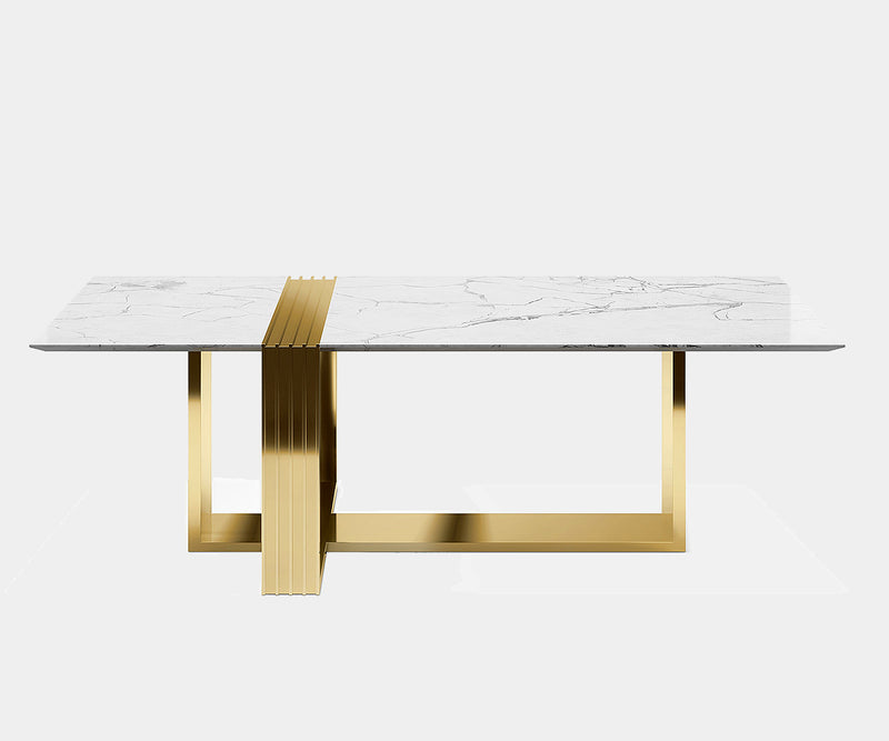 Luxury dining table featuring a Carrara marble surface and geometric brass base by Luxxu