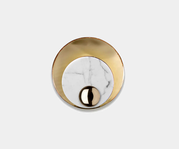 Close-up of Boca do Lobo Metamorphosis wall lamps with high-end marble and brass design.