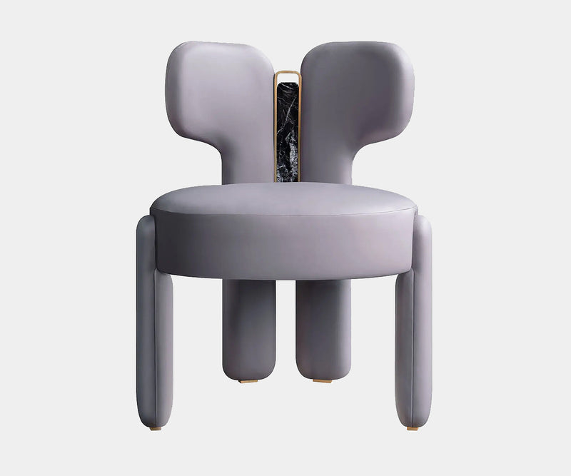 Luxury natural leather dining chair with marble and brass accents in a modern dining room.