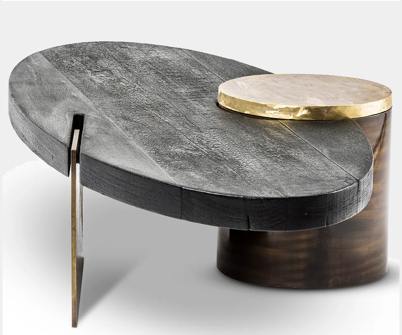 Luxury coffee table with Shou Sugi Ban timber and gleaming brass accents, showcasing an innovative sculptural form for modern interiors.