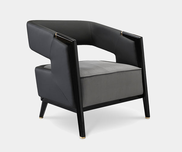 Luxxu Gladia Armchair with grey velvet upholstery and polished brass accents for modern luxury interiors.