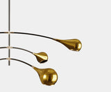 Mid-Century Modern Ceiling Lamp Design: Black Metal & Gold Accents.  The Arlo ceiling lamp by Mezzo Collection embodies the essence of mid-century modern design. This image highlights the lamp's key design elements: a sleek black metal pole, contrasting beautifully with the warmth of the gold-plated brass accents and the light-diffusing glass enclosures.