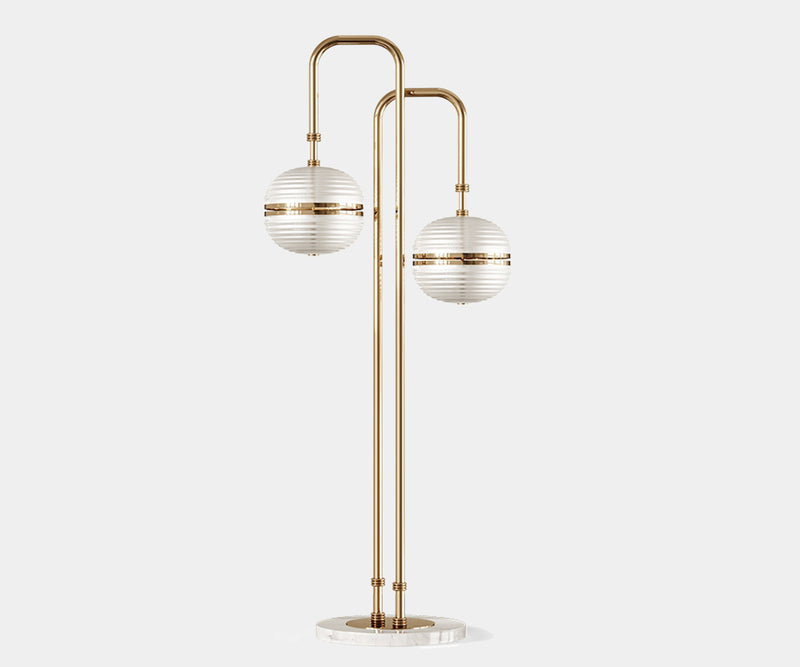 Miles: Modern Floor Lamp in Gold-Plated Brass & Glass Globes.  The Miles floor lamp by Mezzo Collection embodies modern grandeur. This striking piece features a flowing gold-plated brass frame cradling delicate glass globes, casting a warm and inviting glow in any modern living space. Inspired by the legendary Miles Davis, it creates a bold statement with its luxurious materials and captivating design.