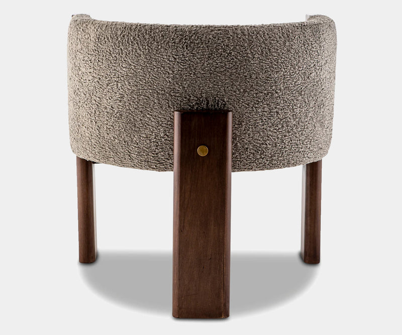 High-end dining chair with grey bouclé fabric and minimalist walnut frame, ideal for contemporary luxury spaces.