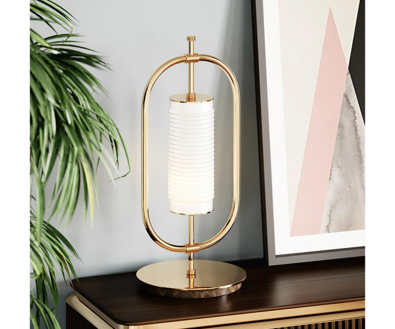 Minimalist Table Lamp Design: Gold-Plated Brass & Marble.  The Beaumont table lamp by Mezzo Collection showcases the enduring power of minimalist design. This image highlights the lamp's key features: a sleek oval frame in gleaming gold-plated brass and a luxurious Carrara marble base.