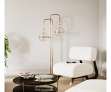 Modern Floor Lamp Design: Gold-Plated Brass & Glass Globes.  The Miles floor lamp by Mezzo Collection showcases the perfect balance of modern design and timeless elegance. This image highlights the lamp's key features: a flowing, gold-plated brass frame that gracefully supports delicate, light-diffusing glass globes.