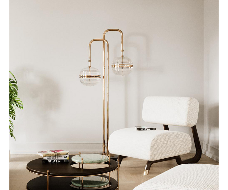 Modern Floor Lamp Design: Gold-Plated Brass & Glass Globes.  The Miles floor lamp by Mezzo Collection showcases the perfect balance of modern design and timeless elegance. This image highlights the lamp's key features: a flowing, gold-plated brass frame that gracefully supports delicate, light-diffusing glass globes.