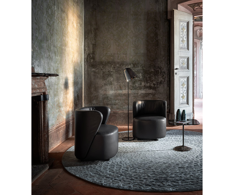 Modern black leather armchair by Ghidini 1961, perfect for luxury real estate interiors.