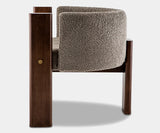 Modern grey bouclé dining chair with sleek walnut frame, combining comfort and style for luxury interiors.