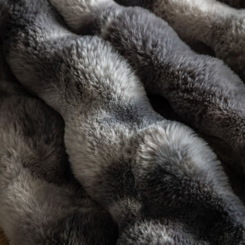 The Neutral Marble Faux Fur Throw blends seamlessly with any decor. This luxurious throw features a timeless grey and white marble pattern, making it a versatile addition to your home.
