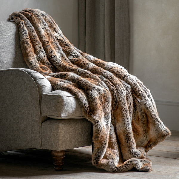 Urban Wolf Luxe Faux Fur Throw. Unleash your inner urban wolf with this sumptuously soft, faux fur throw featuring a deep pile and a subtle striped pattern. Perfect for adding a touch of cosy luxury to any space.